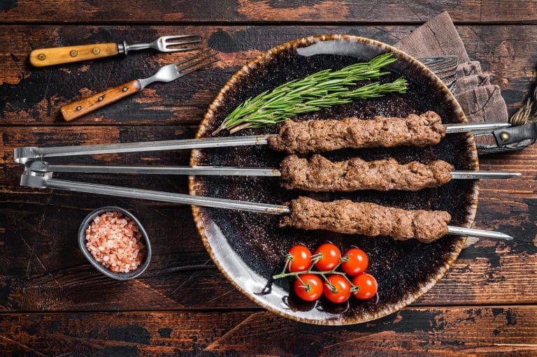Grilled Shish kebab on skewers from minced lamb beef meat, Lula kebab. Wooden background. Top view