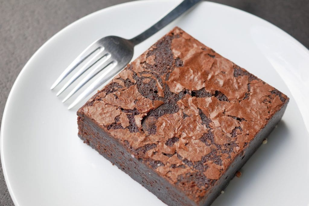 slice of brownie on plate on table