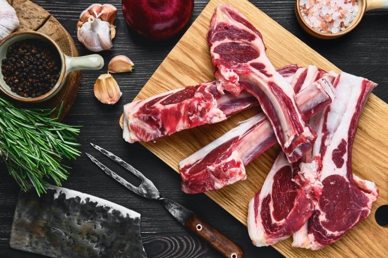 Top view of raw lamb rib chops on cutting board