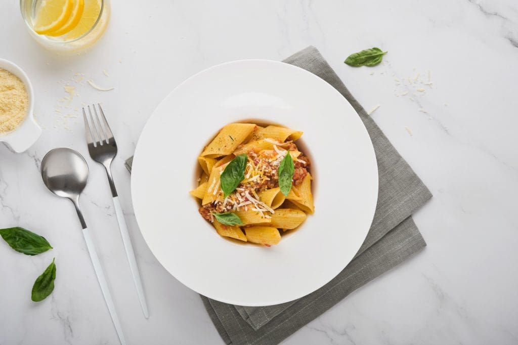 Bolognese Penne Pasta. Tasty appetizing classic italian penne pasta with parmesan cheese, basil and
