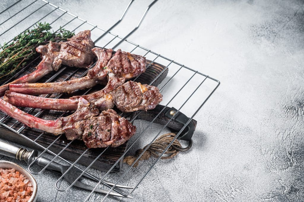Barbecue grilled lamb meat chop on a grill, mutton rib cutlet. White background.