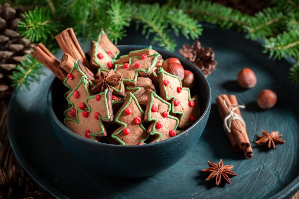 Sweet gingerbread cookies for Christmas on rustic tray