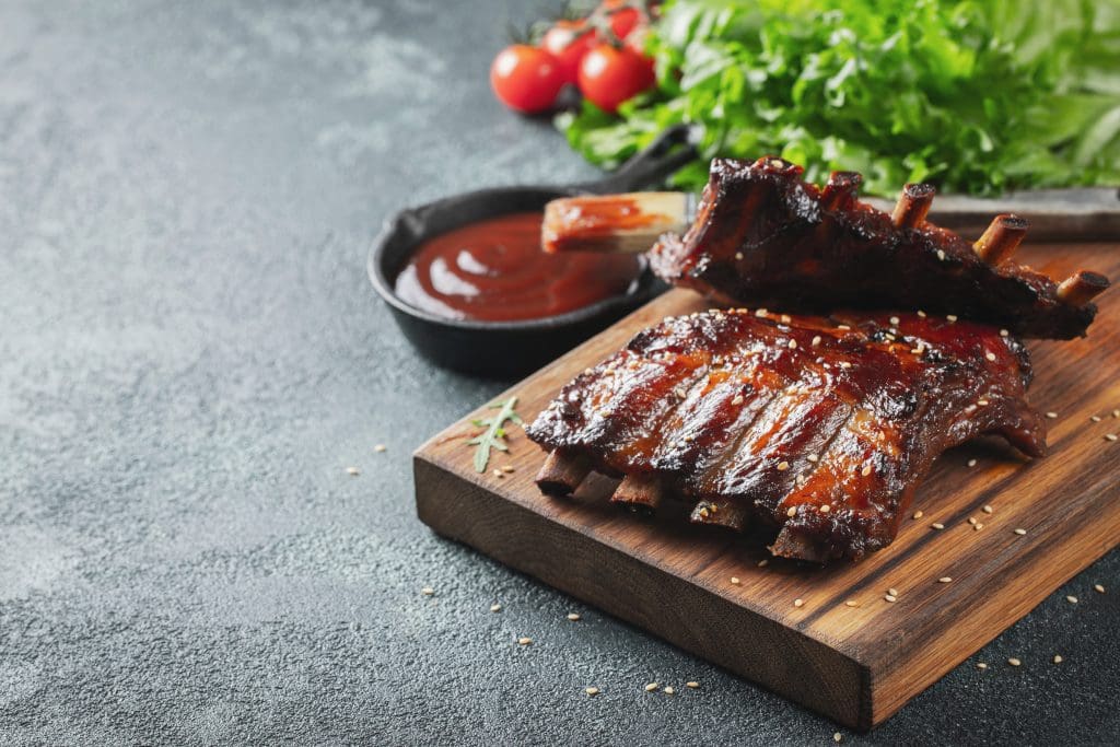 Closeup of pork ribs grilled with BBQ sauce and caramelized in honey.