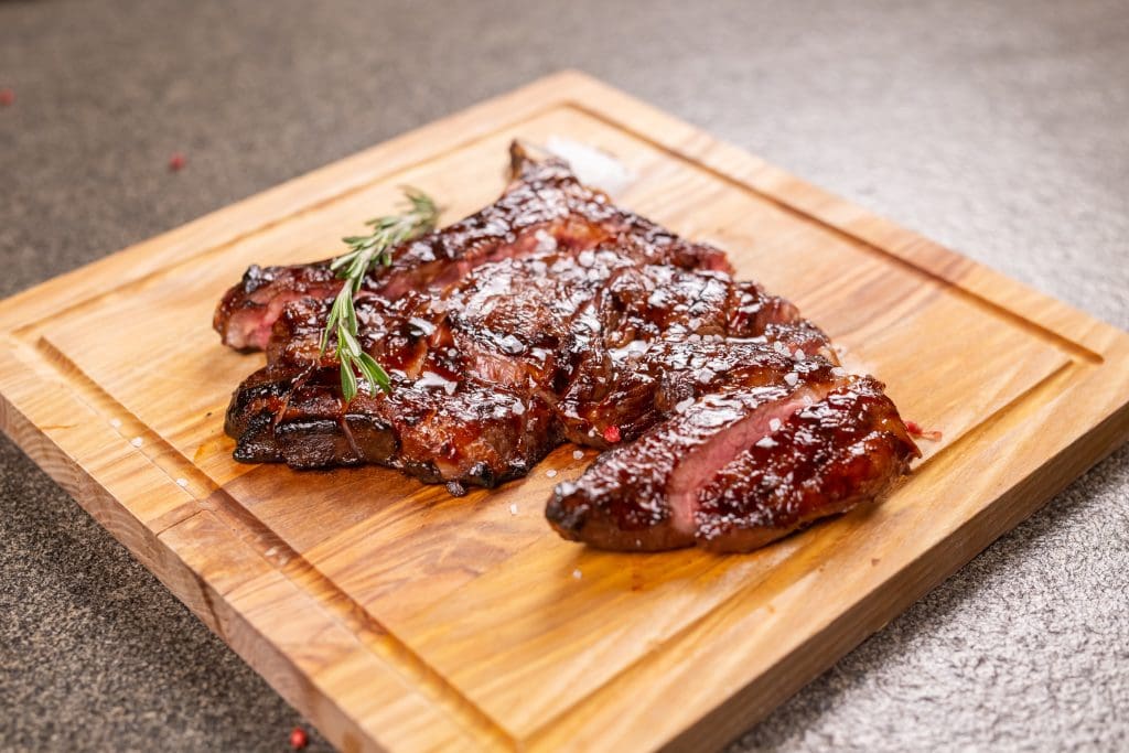 Food, delicious, horse meat and craft concept - serving of grilled steak