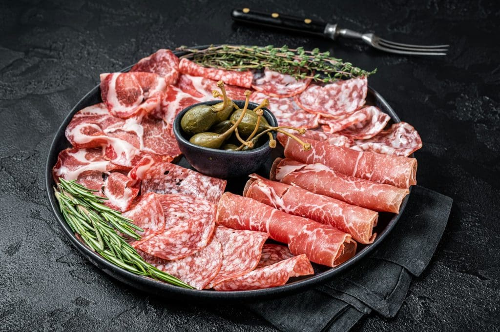 Italian Antipasto set platter, cured meat plate with Prosciutto crudo, Salami and Coppa Sausage.