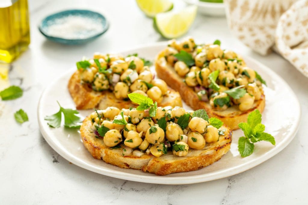 Healthy bruschetta with chickpea salad and herbs