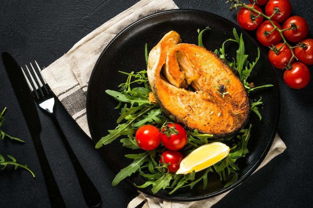 Salmon fish with fresh salad