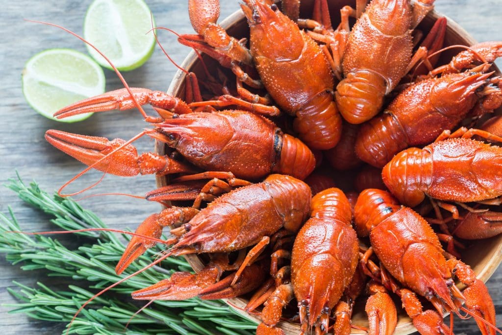 Bowl of boiled crayfish on the wooden table
