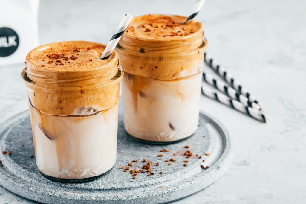 Dalgona coffee. Iced coffee with creamy whipped foam and almond milk.